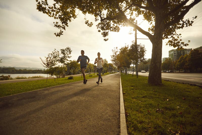 Couple running at sunrise for heart health