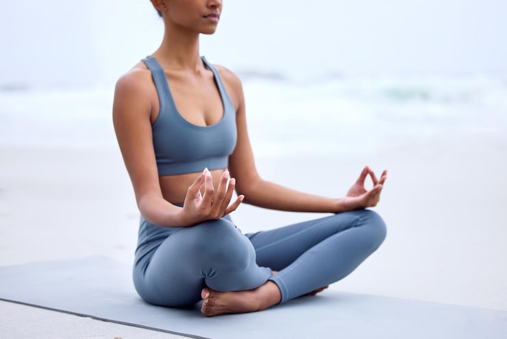 Woman meditating peacefully at the seaside